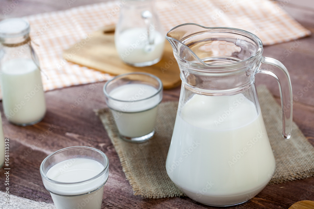 milk and glasses of milk on a wooden rustic table. milk and glasses of milk on a wooden rustic table.