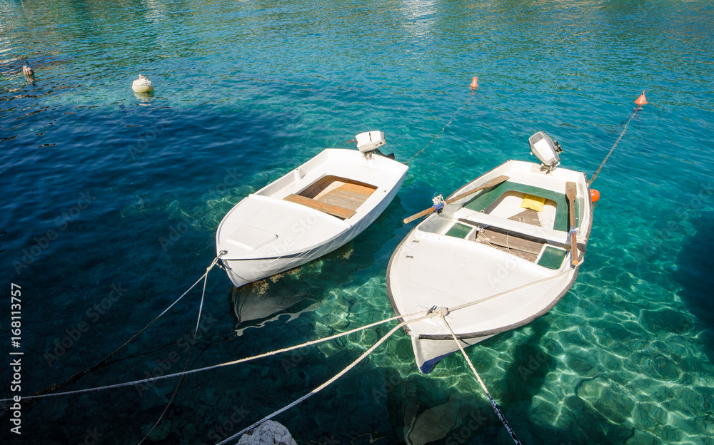 Boats in clear blue sea in summer time