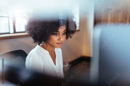 Young african woman working in her office