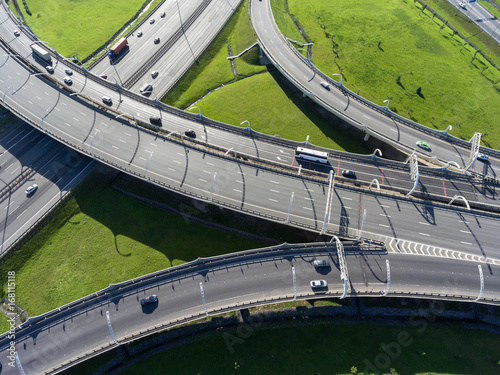 Wall Mural Multi-level interchange of city ringroad with driving vehicles