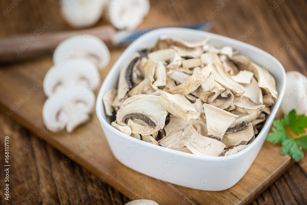 Portion of Dried Mushrooms on wooden background, selective focus Portion of Dried Mushrooms on wooden background, selective focus