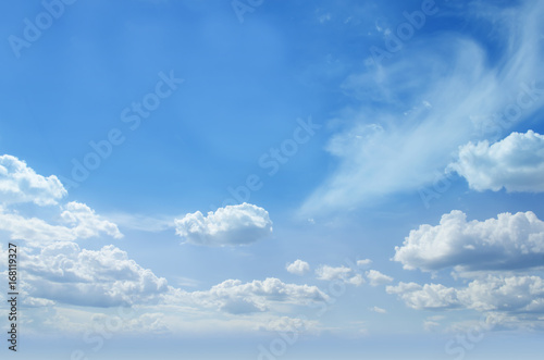Blue sunny skies partial with clouds background. Photo.