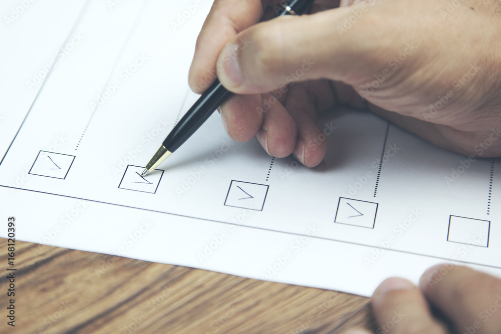businessman preparing checklist at office desk