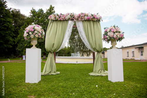 Beautiful wedding ceremony outdoors. Decorated chairs stand on the grass. rustic style.