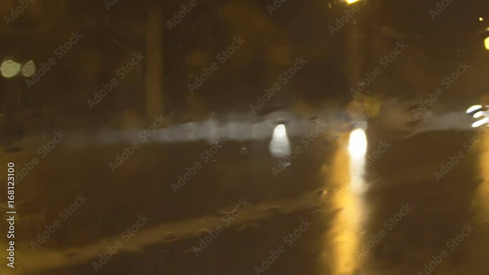 slow motion video of night traffic in a heavy downpour