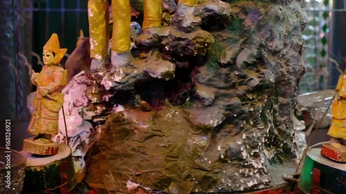 Rotating statuettes in the Buddhist temple photo