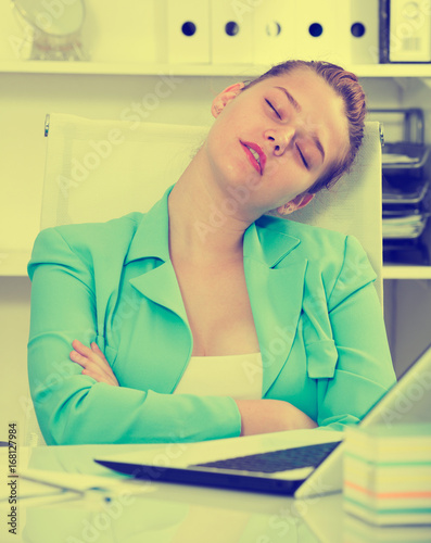 Office manager woman is sleeping after productive day at work