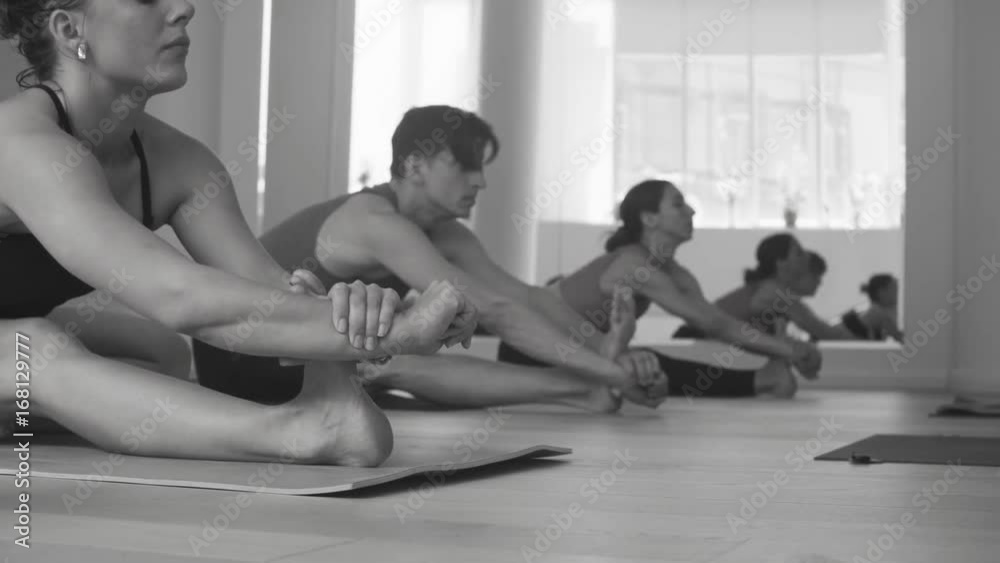 Group of people doing yoga asanas in studio Group of people doing yoga asanas in studio