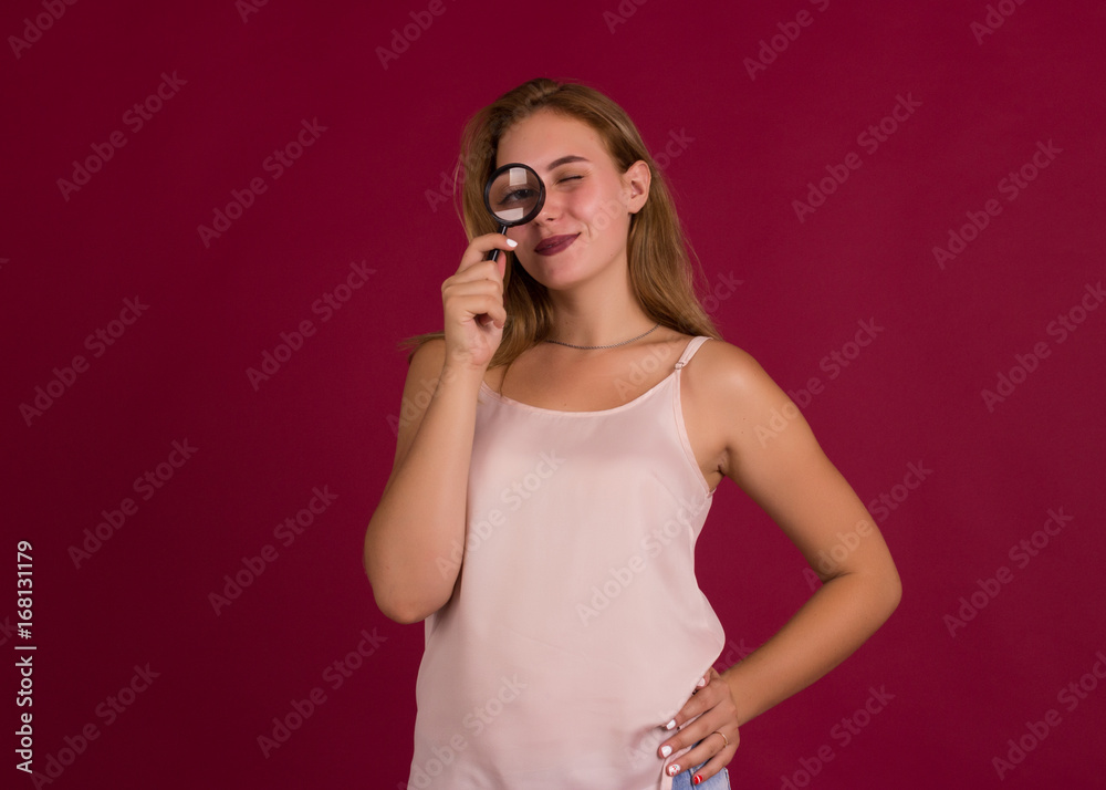 Young pretty girl with magnifier, studio Young pretty girl with magnifier, studio
