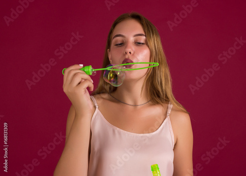 Young cute girl blows bubbles, pretty woman 