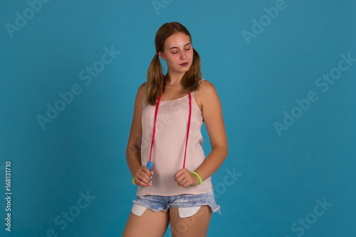 Young pretty girl with jump rope, studio 