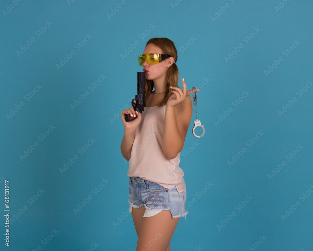 Young pretty girl with weapon, studio Young pretty girl with weapon, studio