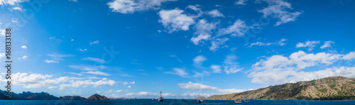 Panoramic blue sky background with white clouds on a sunny day over the sea in flores island, Labuan bajo, Indonesia