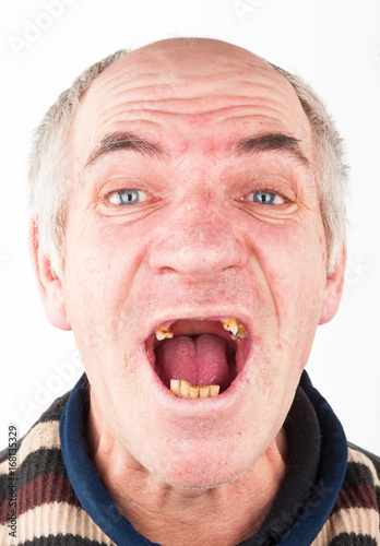 Portrait of elderly man with an open toothless mouth