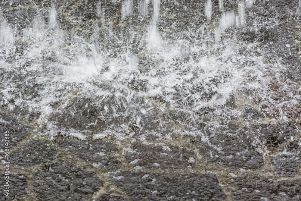 Impacting geyser of water on concrete.