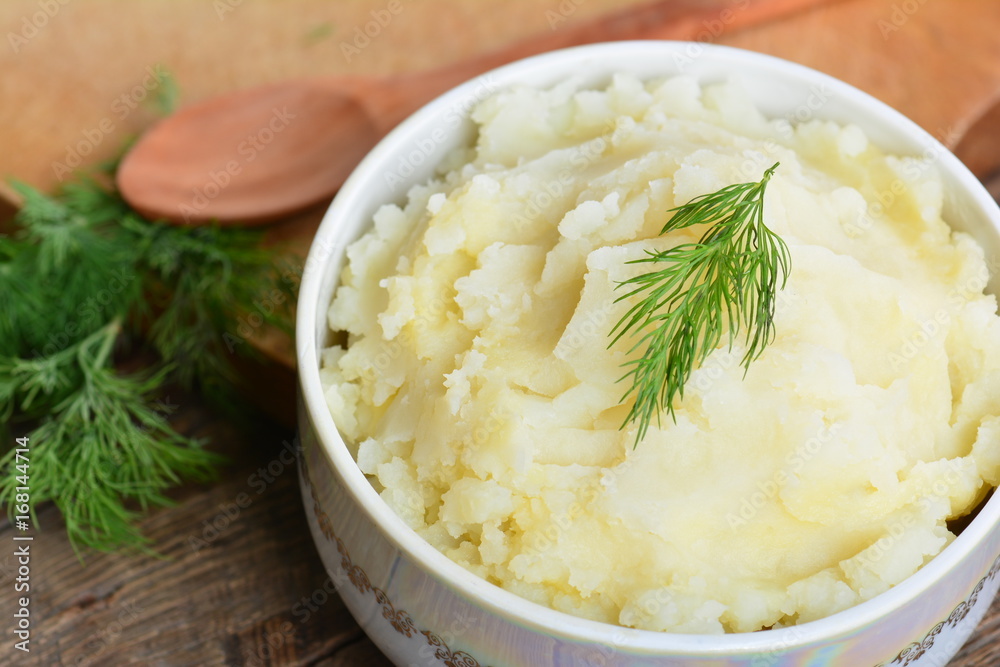 Mashed potatoes, boiled puree in ceramic pot on wooden background Mashed potatoes, boiled puree in ceramic pot on wooden background