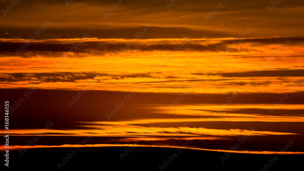 Abstract patterns and texture of golden clouds at sunset over Belgrade, Serbia