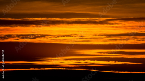 Abstract patterns and texture of golden clouds at sunset over Belgrade, Serbia © banepetkovic