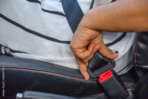 Women are locking the car seat belt. © singjai
