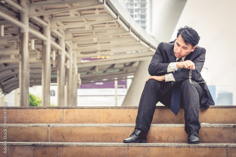 Stressed business man sitting with serious face and feel depressed Stressed business man sitting with serious face and feel depressed