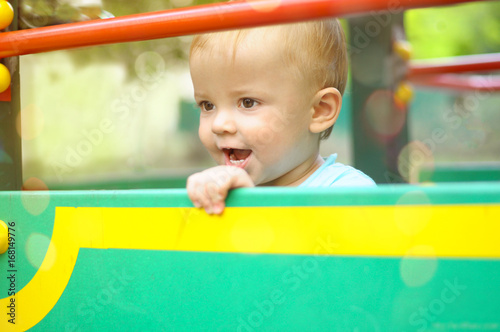portrait of a little boy fascinated by the game on the Playground © volkonskaya
