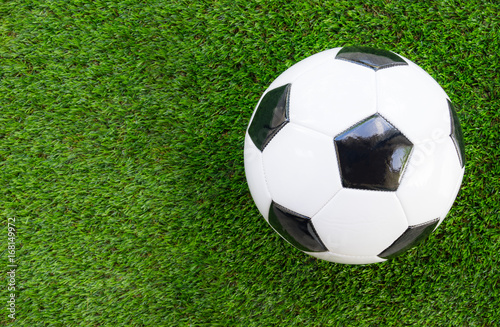 Soccer concept : Football (soccer ball)  on green grass background. Flat lay with copy space. © BoonritP