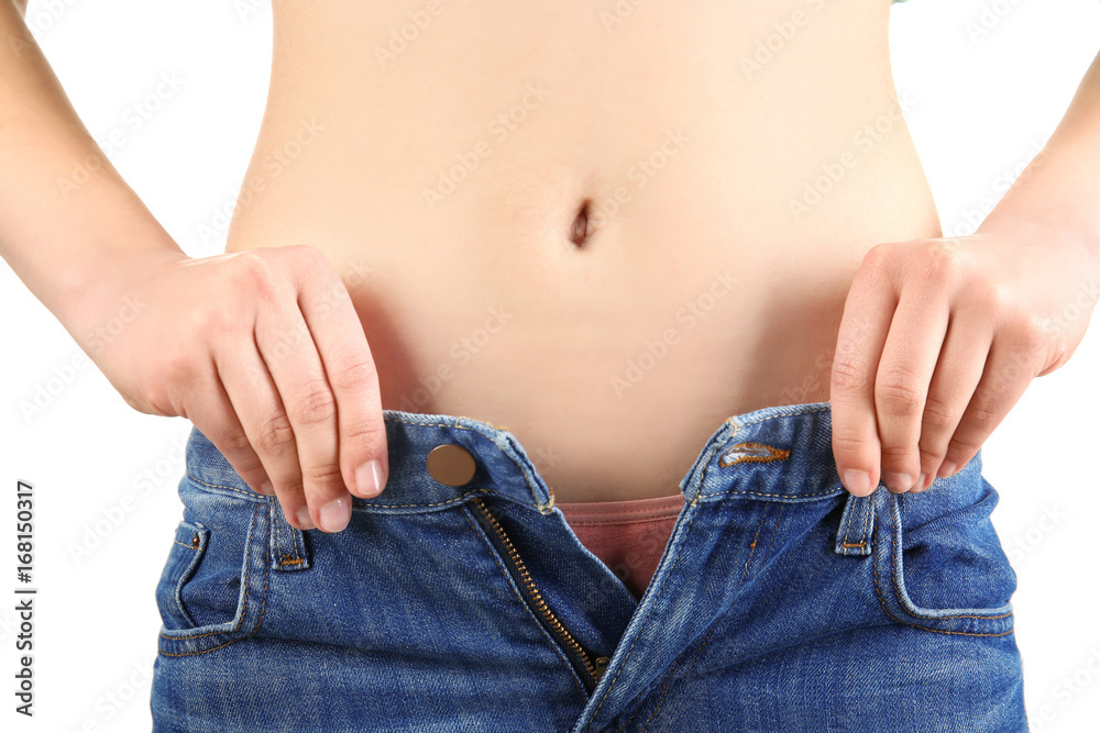 Young woman in tight jeans on white background, closeup. Weight