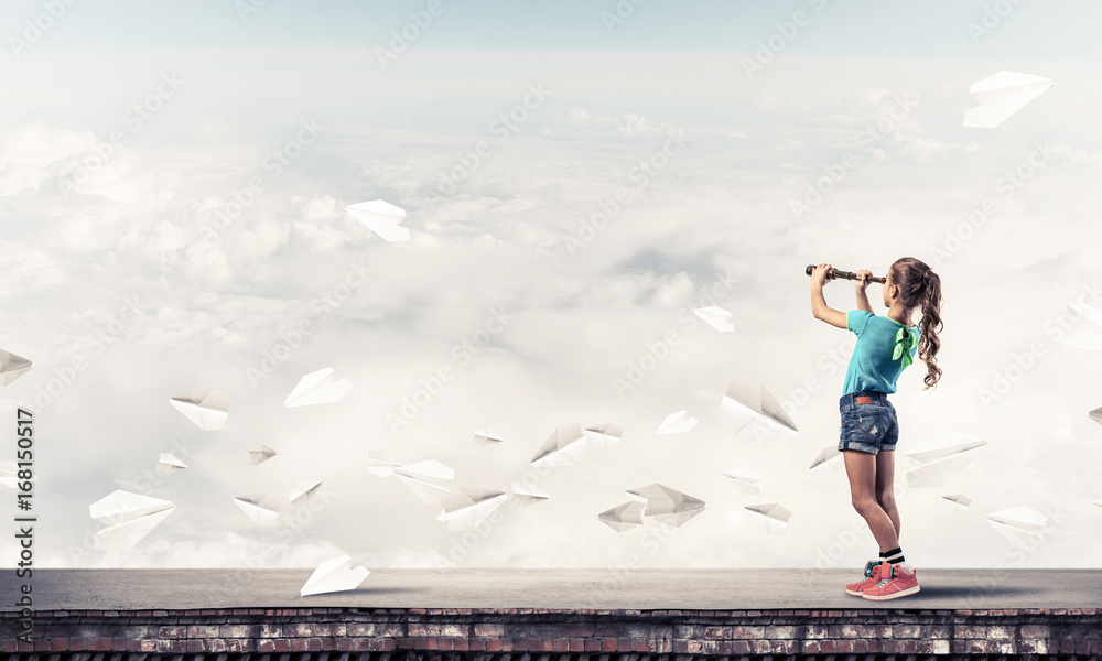 Concept of careless happy childhood with girl exploring this wor Concept of careless happy childhood with girl exploring this wor