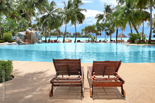 Sun loungers near pool at sea resort © Africa Studio
