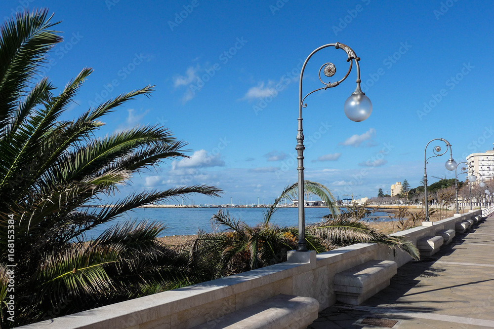Victorian style streetlamps light the seawall in Sicily