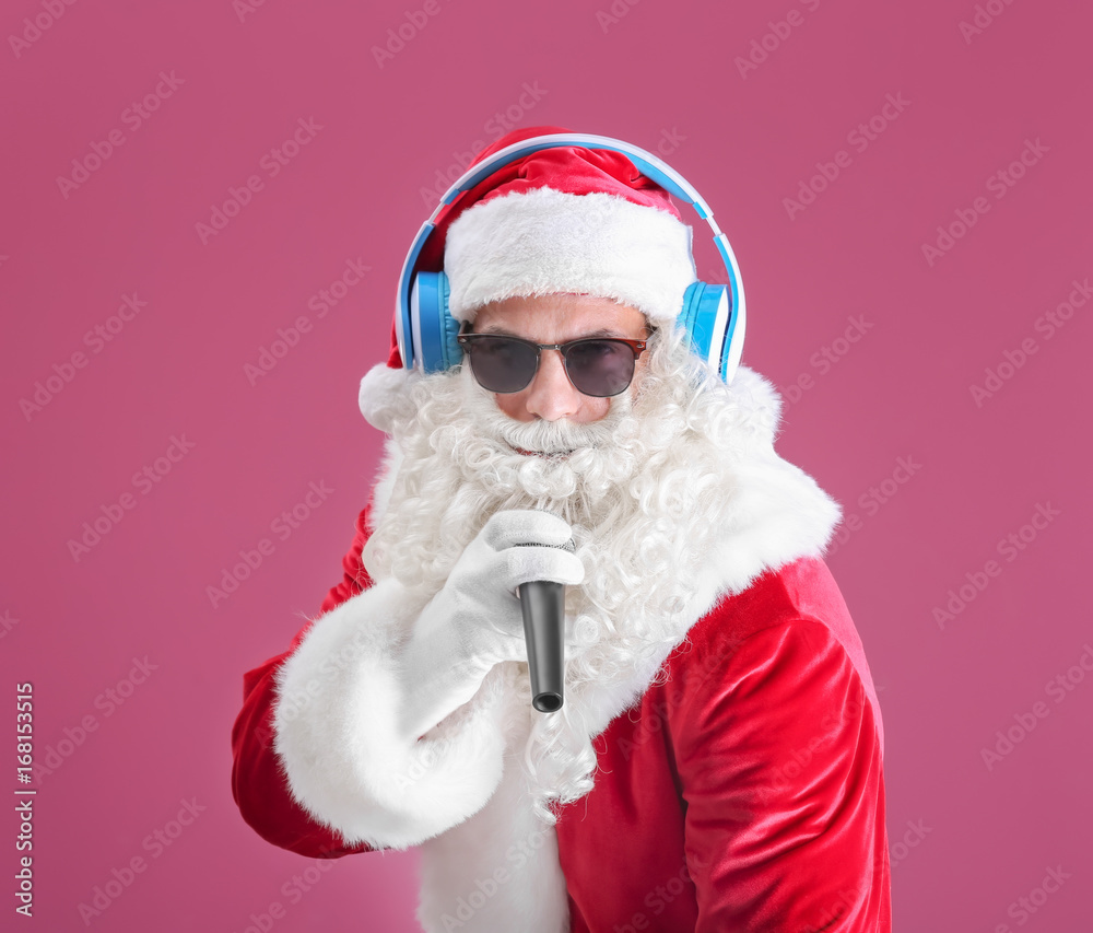 Santa Claus singing Christmas songs on color background Santa Claus singing Christmas songs on color background