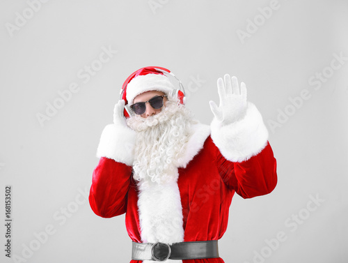 Santa Claus listening to mu...