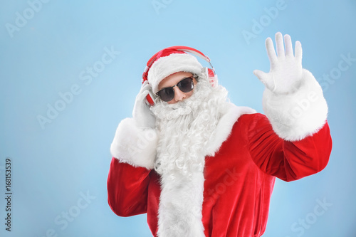 Santa Claus listening to mu...