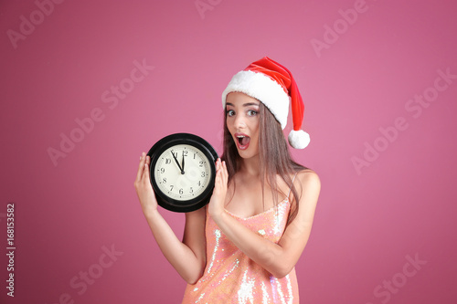 Young woman in Santa hat wi...