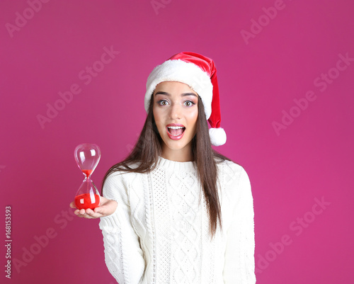 Young woman in Santa hat wi...