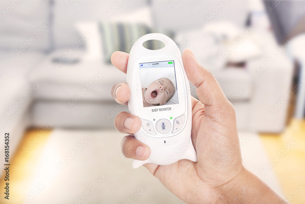 Parent monitoring sleeping baby through baby monitor