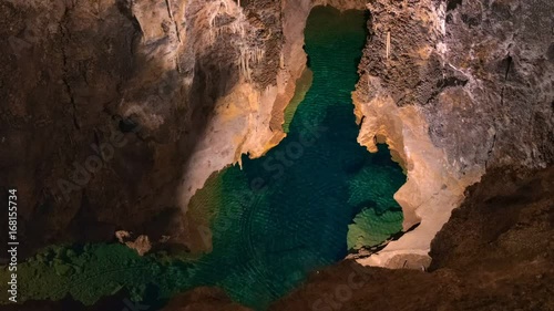 Underground lake sorrunded by rocks photo