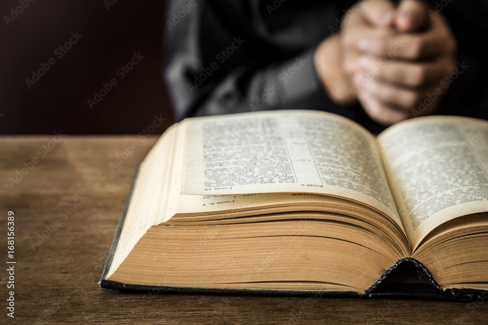 Opened bible in the quiet, dark atmosphere. Prayer time on sunday. Opened bible in the quiet, dark atmosphere. Prayer time on sunday.