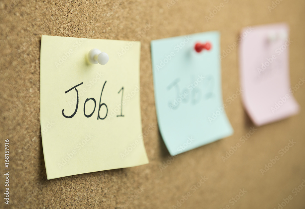 Sticky note on cork board background Sticky note on cork board background