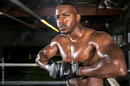 Handsome attractive african american boxer mma fighter exercise fitness athlete resting