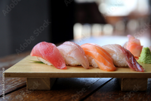 Fotografie Mix sushi tuna salmon sea bass sushi on wood background japanese food