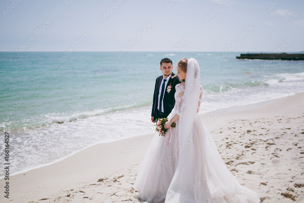 Beautiful bride and groom couple walking at the wedding Beautiful bride and groom couple walking at the wedding