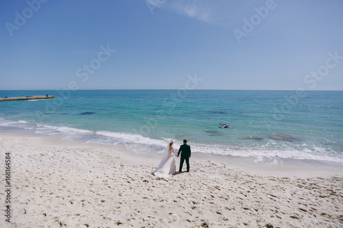 Beautiful bride and groom couple walking at the wedding