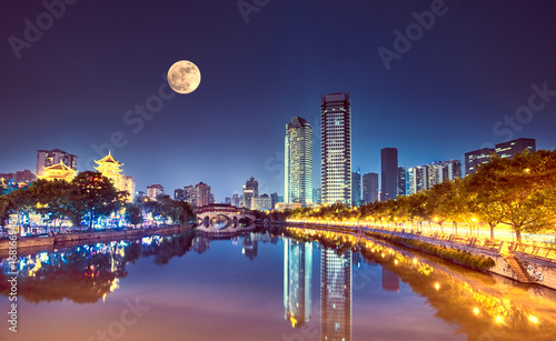The Anshun Bridge crosses the Jin River with the moon in the sky, Chengdu, China.