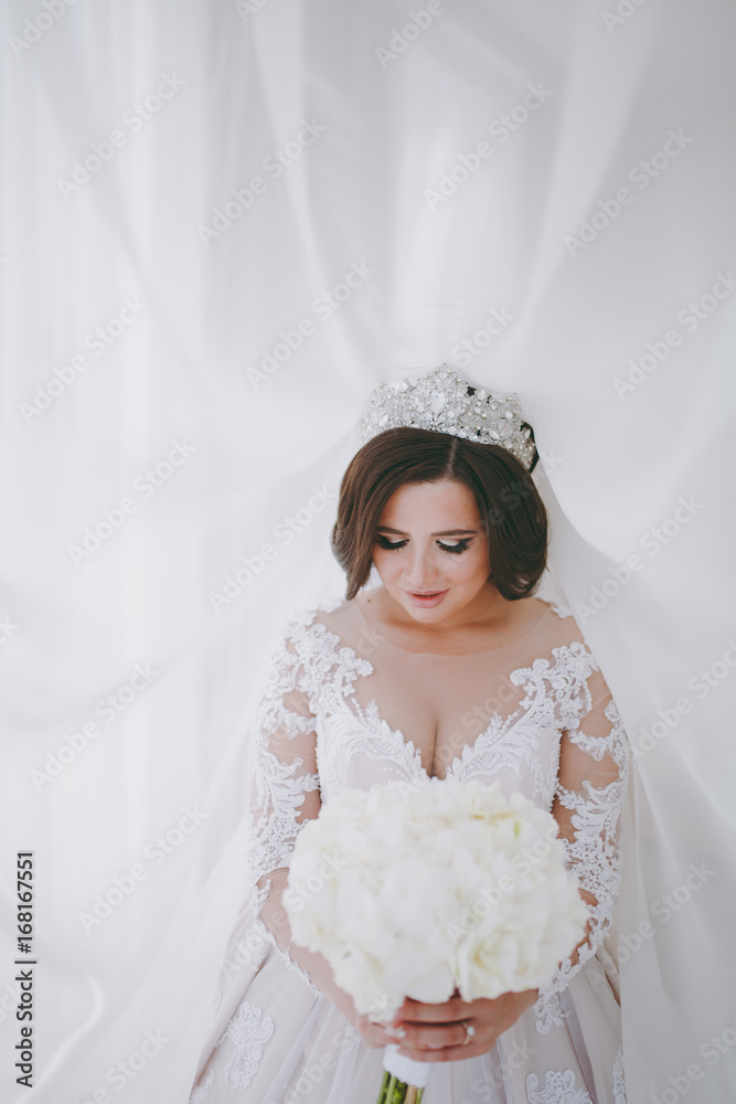 Beautiful bride in wedding dress in apartment Beautiful bride in wedding dress in apartment