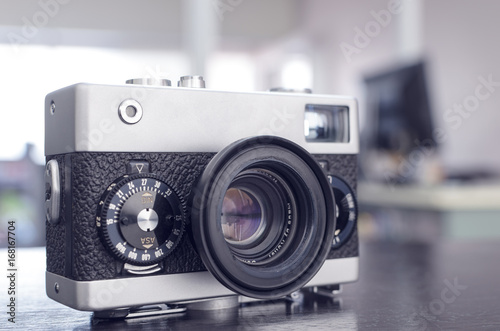 vintage manual rangefinder film camera in two-tone black&silver, shallow depth of field, filter effect