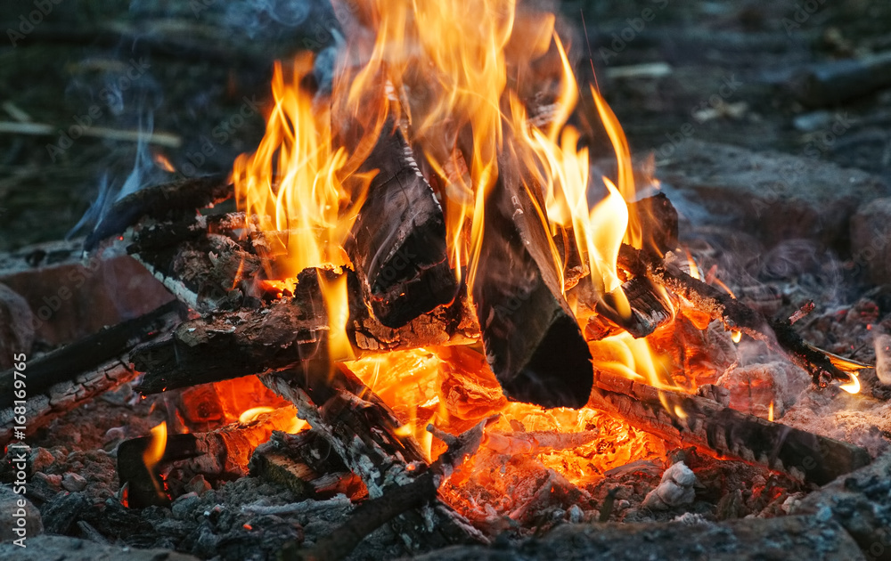 Closeup shot of burning fire with hot red embers in it, selective focus
