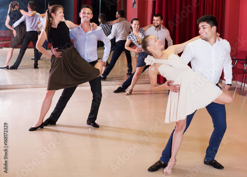 Dancing couples enjoying latin dances