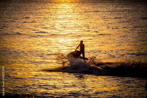 Silhouette of jetski at sunset