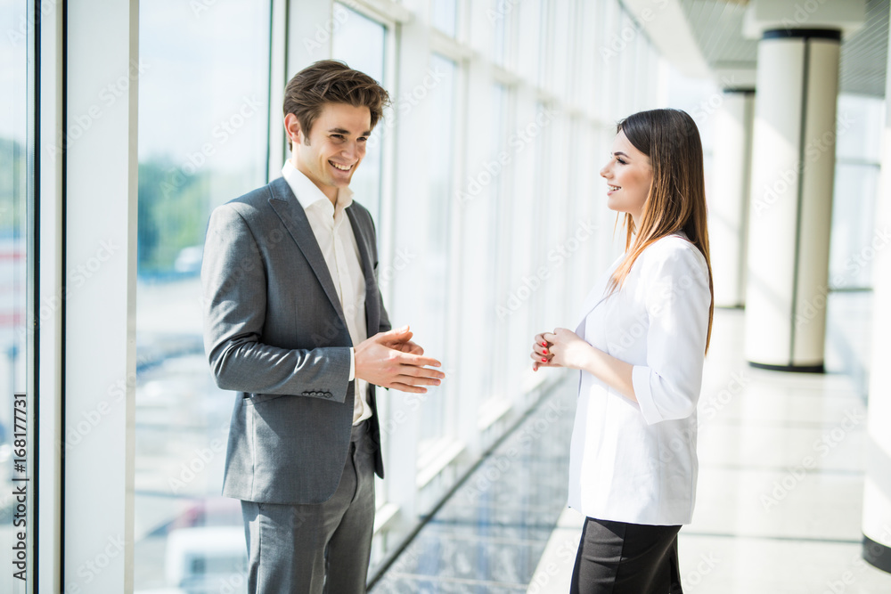 Smiling colleagues meeting speaking together in an office